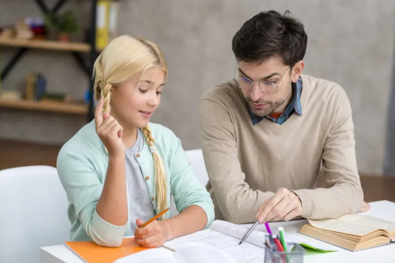 Tutor working with a student at a desk
